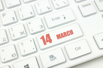 March 14th. Day 14 of month, Calendar date. Cropped view of Modern White Computer Keyboard with calendar date. Concept workspace, freelance, deadline.  Spring month, day of the year concept.