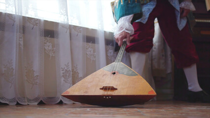 Balalaika wooden in the hands of the musician. Stock. Folk musical art of the rural traditional....