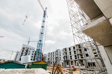 Construction of multi-apartment houses and a new residential complex. Blue sky.