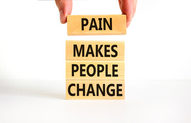 Pain makes people change symbol. Concept words Pain makes people change on wooden blocks on a beautiful white table white background. Business, motivational and pain makes people change concept.