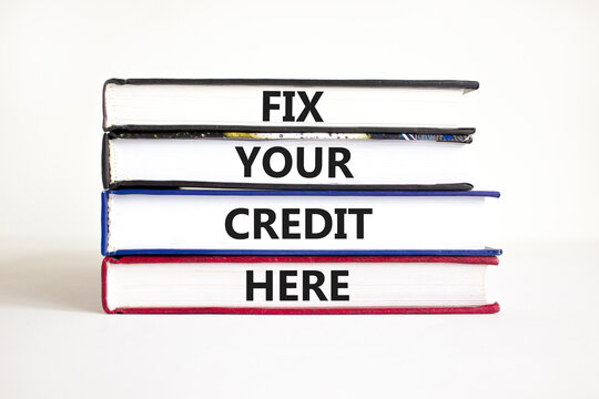 Fix your credit here symbol. Concept words Fix your credit here on books on a beautiful white table white background. Business, finacial and fix your credit here concept.
