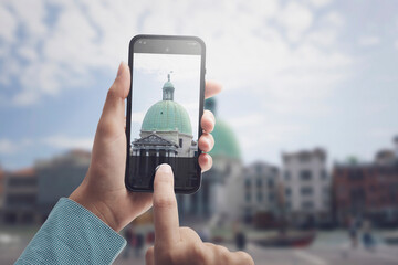 Tourist taking pictures with her smartphone