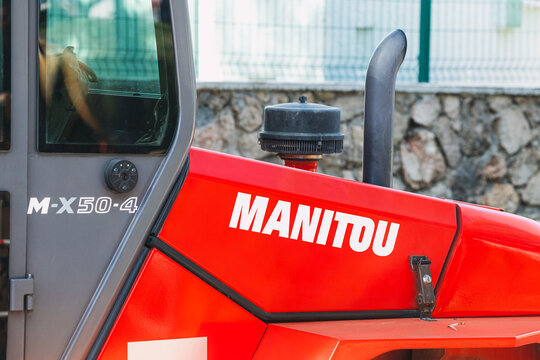 30 May 2022, Antalya, Turkey: French Company Manitou Logo Near Exhaust Pipe Of A Powerful Tractor. The Concept Of Environmental Pollution By Carbon Dioxide Emissions And Agriculture