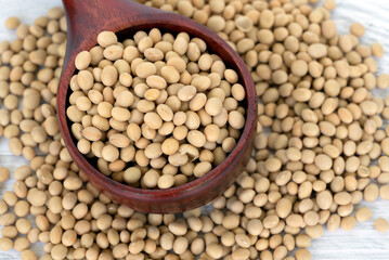 Close up of soybeans on a wood scope white table background