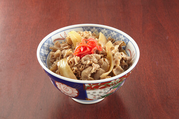 Gyu Don served in a dish isolated on wooden table side view of singapore food