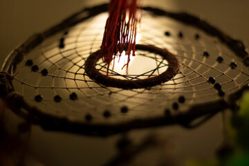 Dreamcatcher in interior. Details of Indian amulet for good sleep. Object woven from threads....