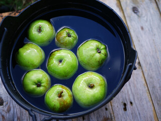 Fresh Apples in a cauldron for bobbing at Halloween 