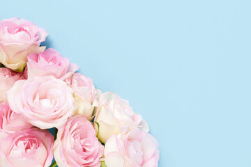 Obraz na płótnie Canvas Pink roses on a light blue background. Mother's day, Valentines Day, Birthday celebration concept