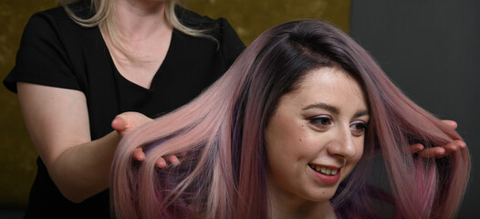 Fototapeta premium Blondy girl with long and volume shiny wavy color hair . Beautiful model with curly hairstyle .