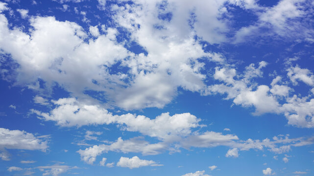 Puffy clouds against a sunny blue sky.