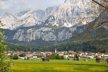 Fototapeta na wymiar Beautilful green meadow and alpine village in spring, Austria