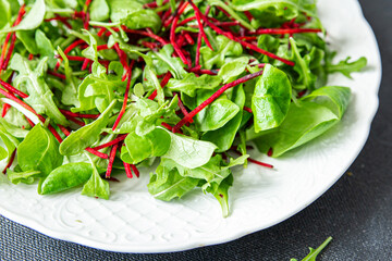 beet salad green leaves mix beetroot, mache leaves, cress fresh healthy meal food snack diet on the table copy space food background rustic  