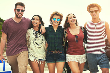 Best buds on the beach. Cropped shot of a group of friends walking on the beach on a summers day.