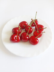 cherries on a white plate on a white background