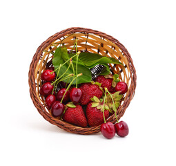 Ripe cherries and strawberries in a basket.