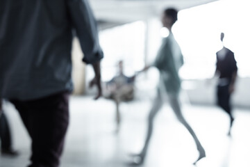 The corporate world never stands still. Cropped shot of a group of businesspeople walking through...