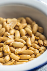 Roasted peeled peanuts in bowl.
