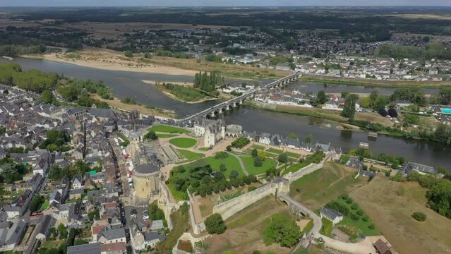 Aerial footage of Royal Castle of Amboise in France Pont du Marechal Leclerc over Loire river. Sunny day, green landscape on the island. Amboise bridge. HD hight quality drone footage