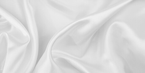 Close-up of rippled white silk fabric texture background
