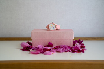 pink silicon watch on rose petals and pink box