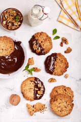 Cookies with walnuts covered with dark chocolate. Delicious homemade dessert.