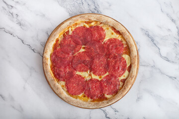 pepperoni pizza on a white stone table
