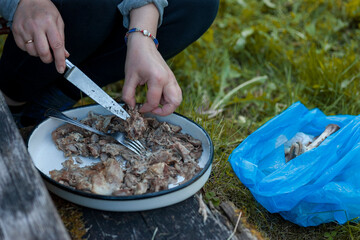 cutting cooked meat with knife