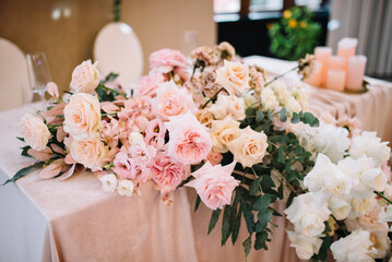 Flower table decorations for holidays and wedding dinner. Table set for holiday, event, party or wedding reception in a restaurant.