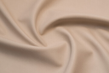 beige artificial leather with waves and folds on PVC base