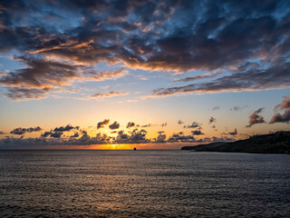 Amazing sunset over the sea with a ship on the horizon.