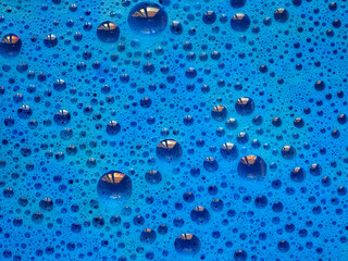 Turquoise blue colorful bath foam with bubbles in the water. Sponge texture effect. Flat lay