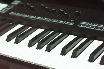 Black white keys piano, synthesizer up close in recording studio.Professional Hi-Fi sound equipment...