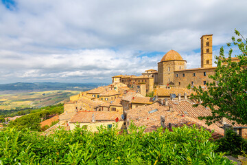 View of the medieval town and cathedral towers of Volterra, Italy, in the hills of Tuscany.