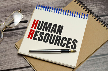 notebook with the word human resources on wooden background