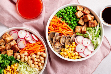 Vegan buddha bowl with tofu, colorful vegetables on base of brown rice.