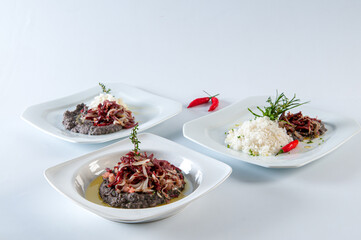 Chef preparing Tutu Beans with Shredded Sun Beef with Onion
