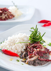 Chef preparing Tutu Beans with Shredded Sun Beef with Onion
