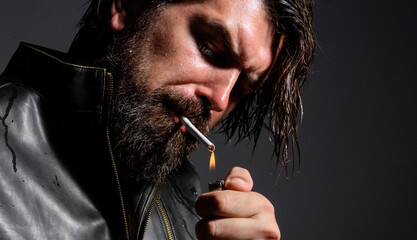 Sensual bearded man smoking cigarette. Stylish hipster with lighter. Addiction of nicotine. Closeup.