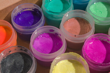 jars with acrylic paints in an open box close-up
