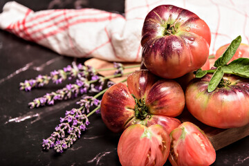 Beautiful fresh tiger tomatoes on dark background.