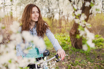 woman with bicycle in park