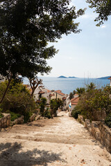 Stairs down, beautiful view of Kalkan village, Kas, Antalya. Cozy narrow streets with white houses, Turkey