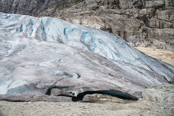 The end of the Jostedalsbreen glacier in Norway formed a small dark cave in the middle of a rocky...