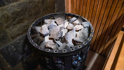 Close-up of sauna stove covered with stones on which water is thrown in order to produce steam.