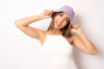 Young beautiful brunette woman wearing casual dress and summer hat over white background smiling with happy face looking to the camera.