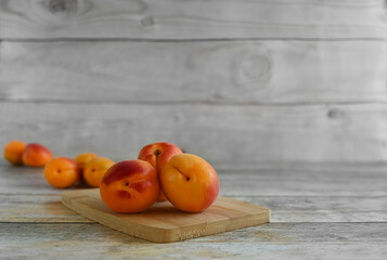 Fresh ripe apricots on a wooden table, copy space . Apricots are rich in vitamins and minerals such as: vitamin A, beta-carotene, vitamin C, potassium, silicon, cobalt, manganese, copper