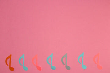 musical notes on pink background, above copy space, creative art design