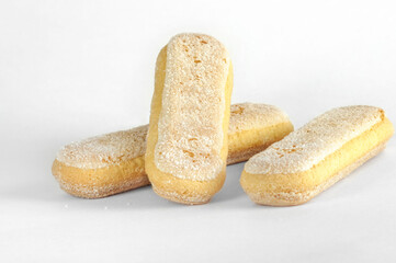 Cookies 3 pieces, lady finger close-up on a white background. Natural light, selective focus with copy space