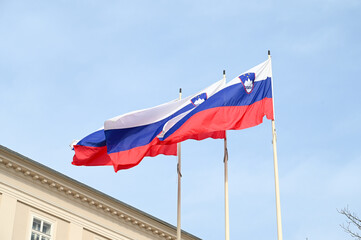 Flags of Slovenia waving on the wind. Slovenian flag on the pole in Ljubljana. 