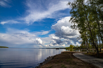 Fototapeta na wymiar A lake in Karelia on a sunny day with a beautiful reflection. Nature of Karelia.